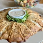 A baked ham and swiss crescent roll ring.