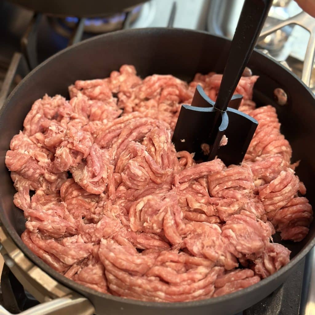 Pork being crumbled for korean bbq sandwiches.