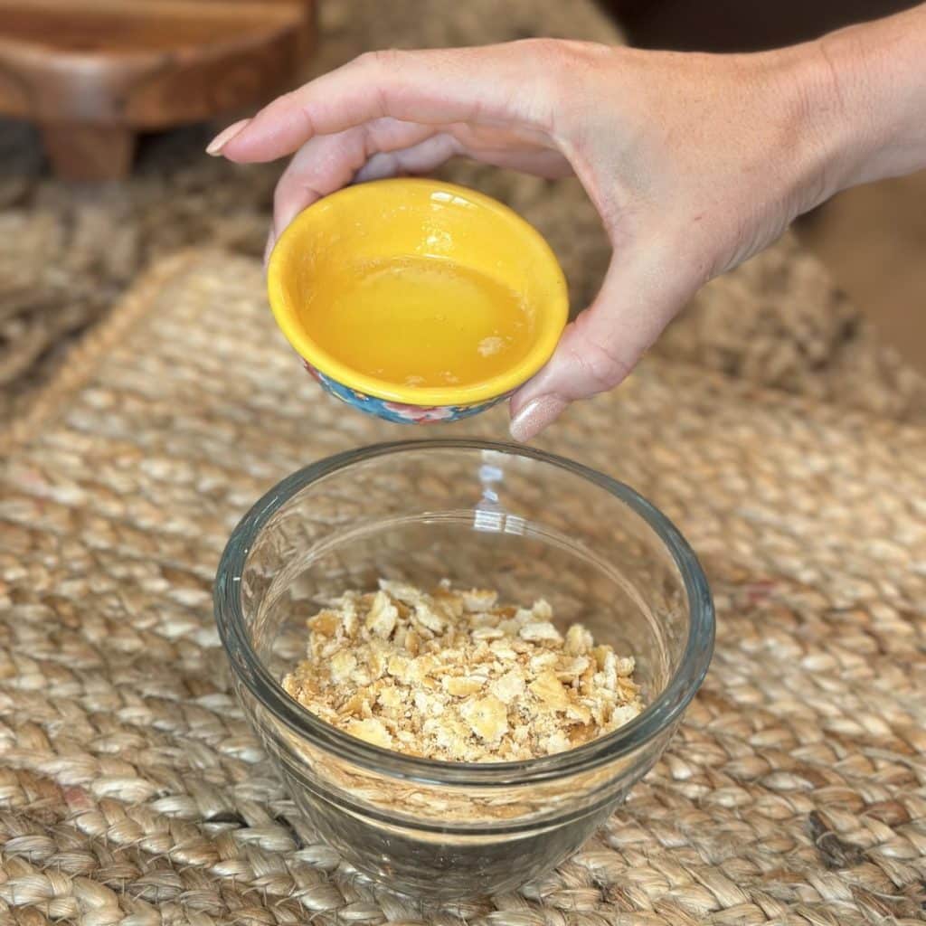 Adding butter to cracker crumbs.