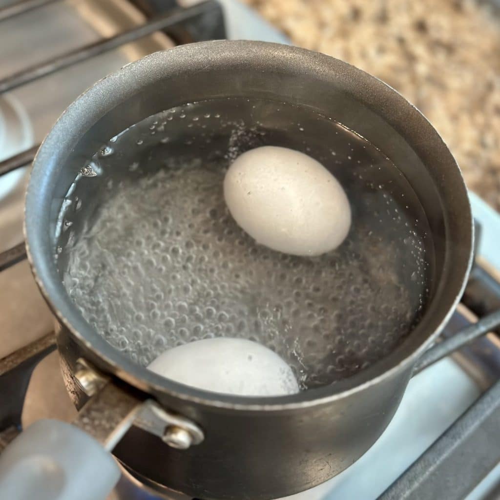 Boiling eggs in a saucepan.