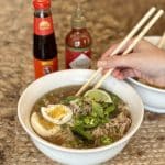 A garnished bowl of cooked ramen.