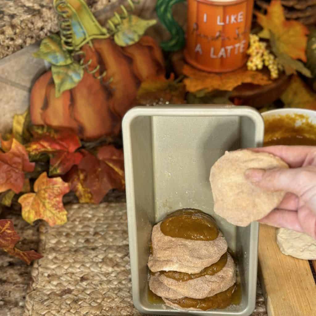 Stacking dough and filling in a loaf pan.