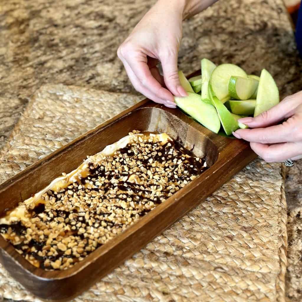 Placing apples in a dip container.