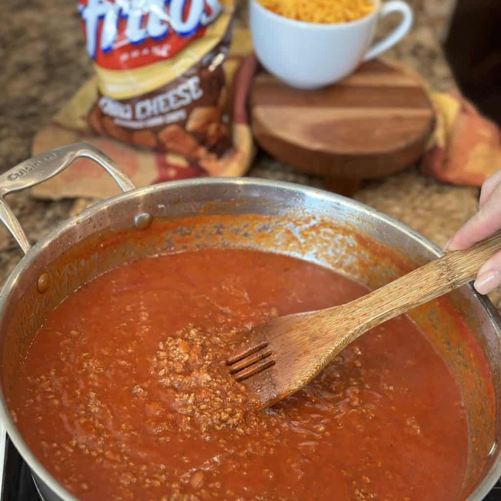 Stirring chili in a pot.