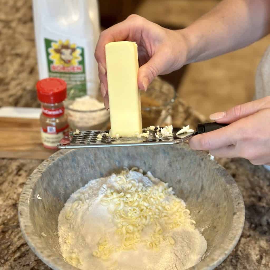 Grating butter into flour.