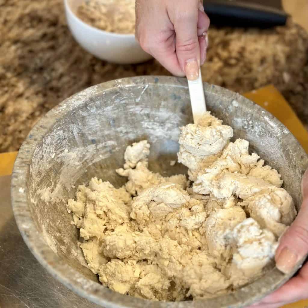 Mixing biscuit dough in a bowl.