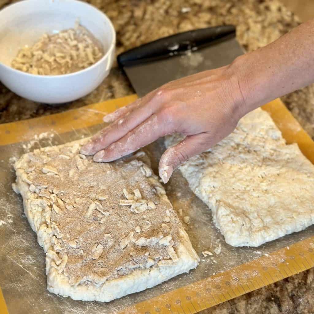 Pressing streusel on biscuit dough.