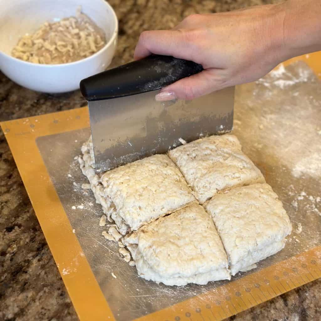 Cutting biscuits into squares.