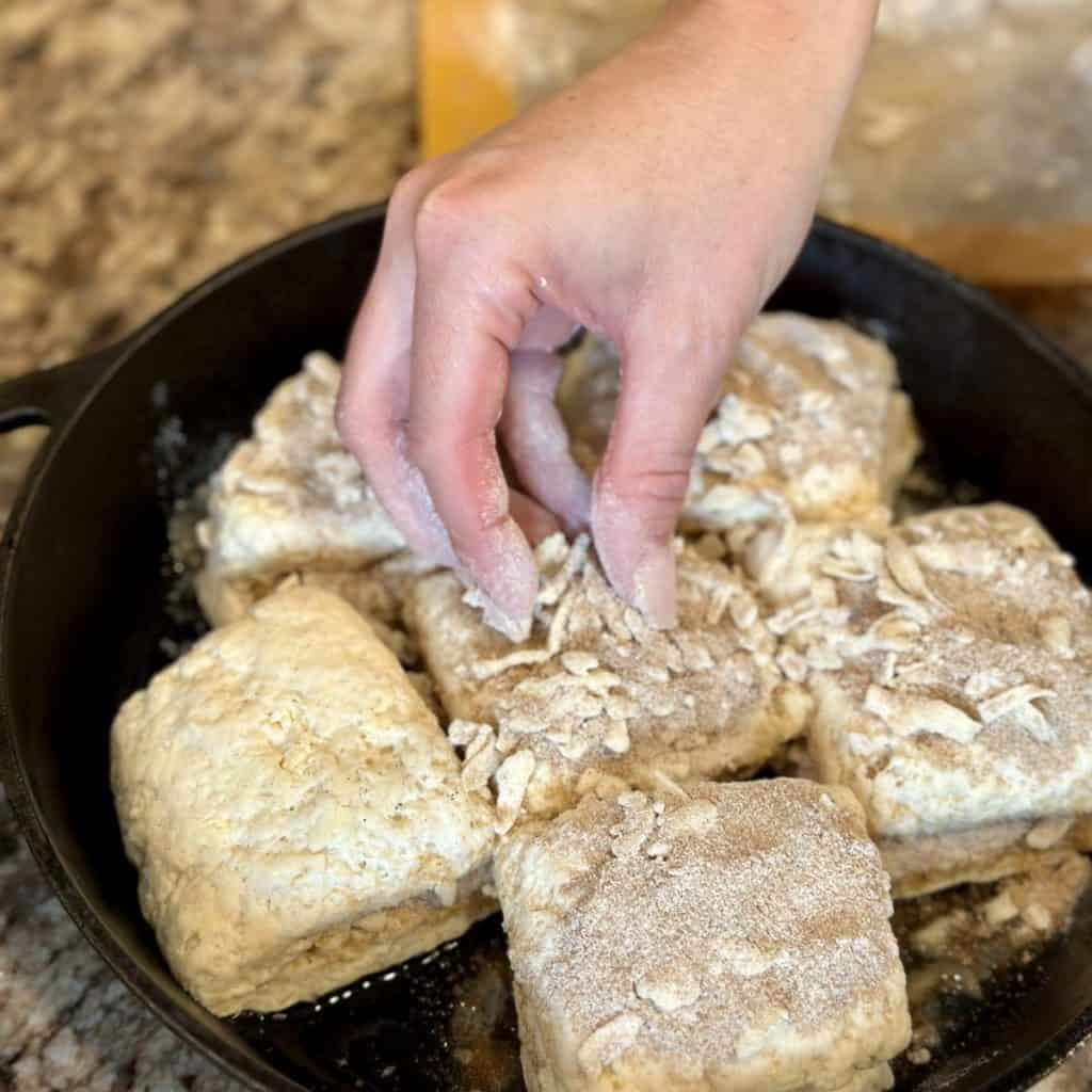 Sprinkling streusel on the tops of biscuits.