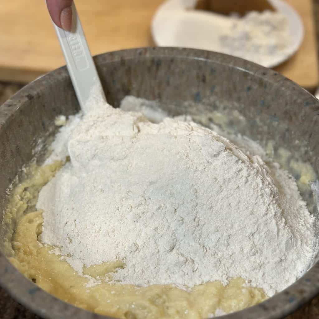 Blending wet and dry ingredients for muffins.