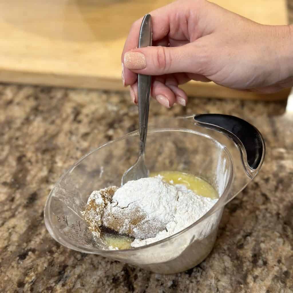 Whisking together streusel ingredients for muffins.