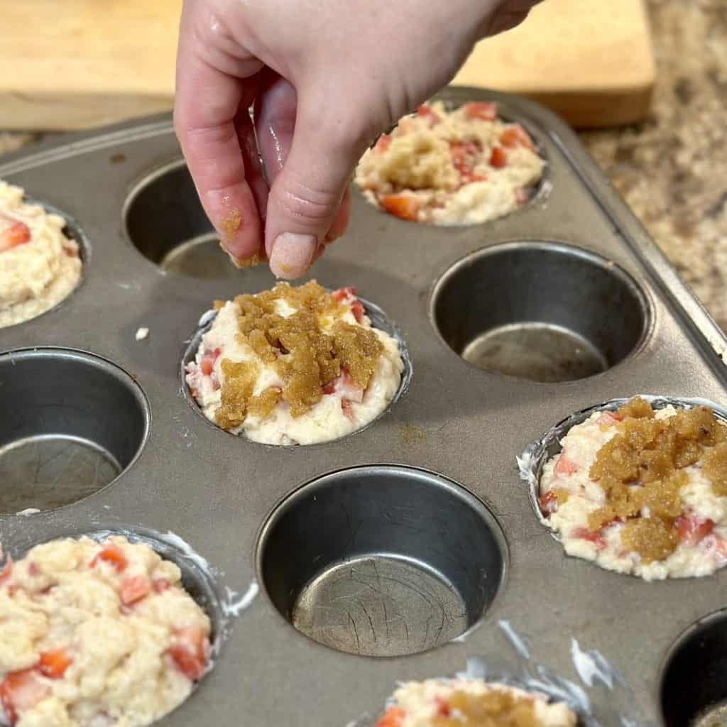 Sprinkling streusel on the tops of batter.