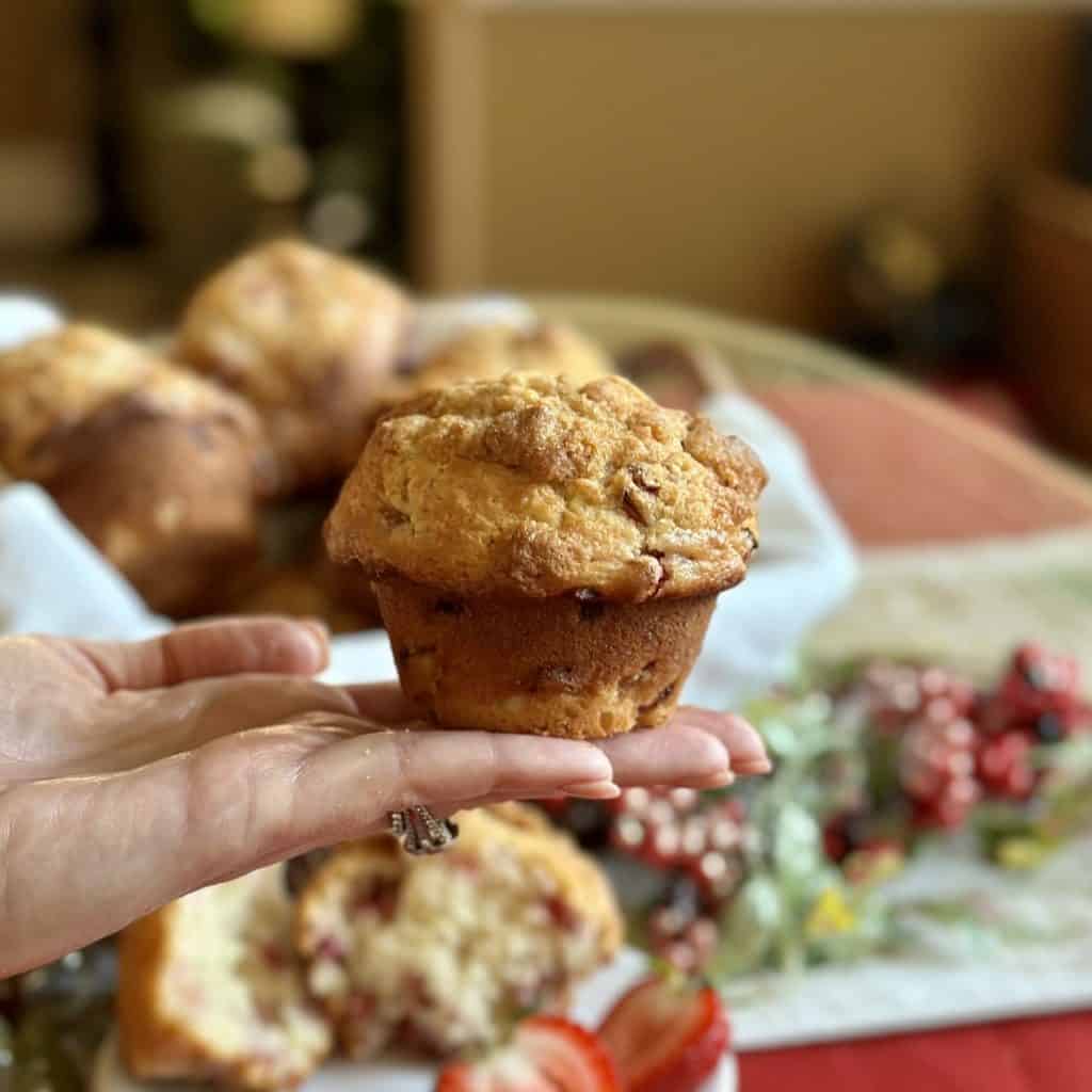 Holding a bakery style muffin.