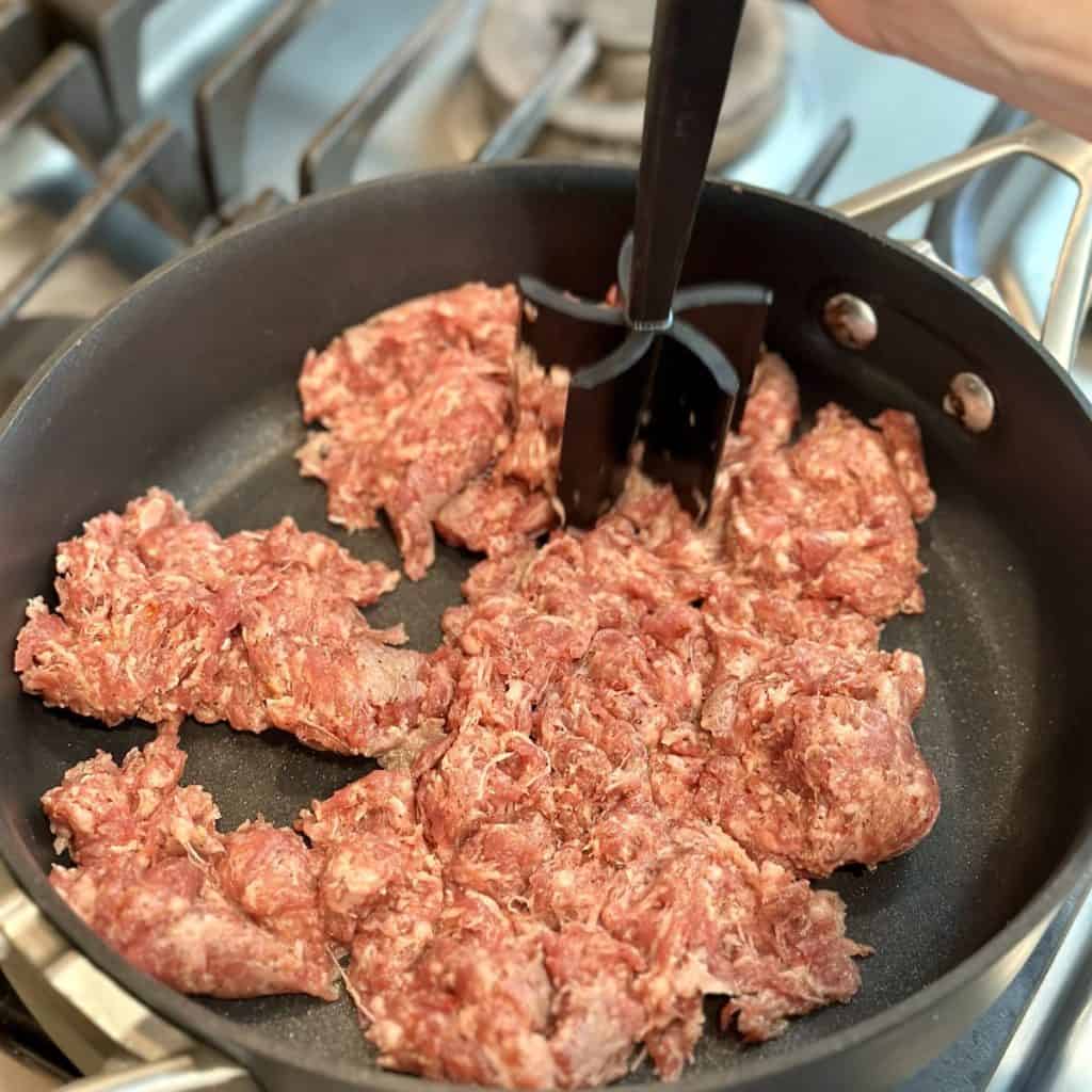 browning sausage in a skillet.