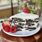 A slice of oreo icebox cake with berries.