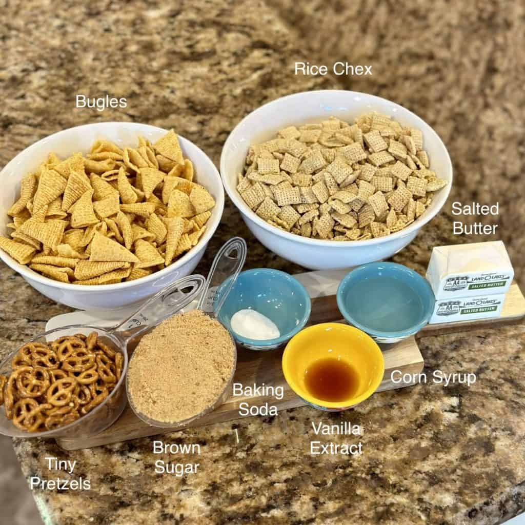 The ingredients displayed that are needed to make a Chex mix.