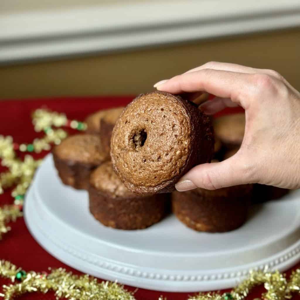 A person holding a mini spice cake.