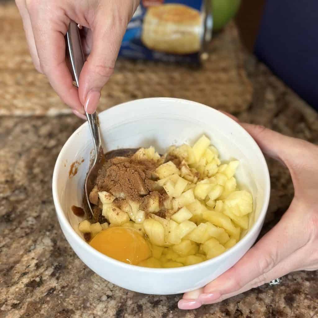 Mixing together an apple butter filling for an apple butter loaf.