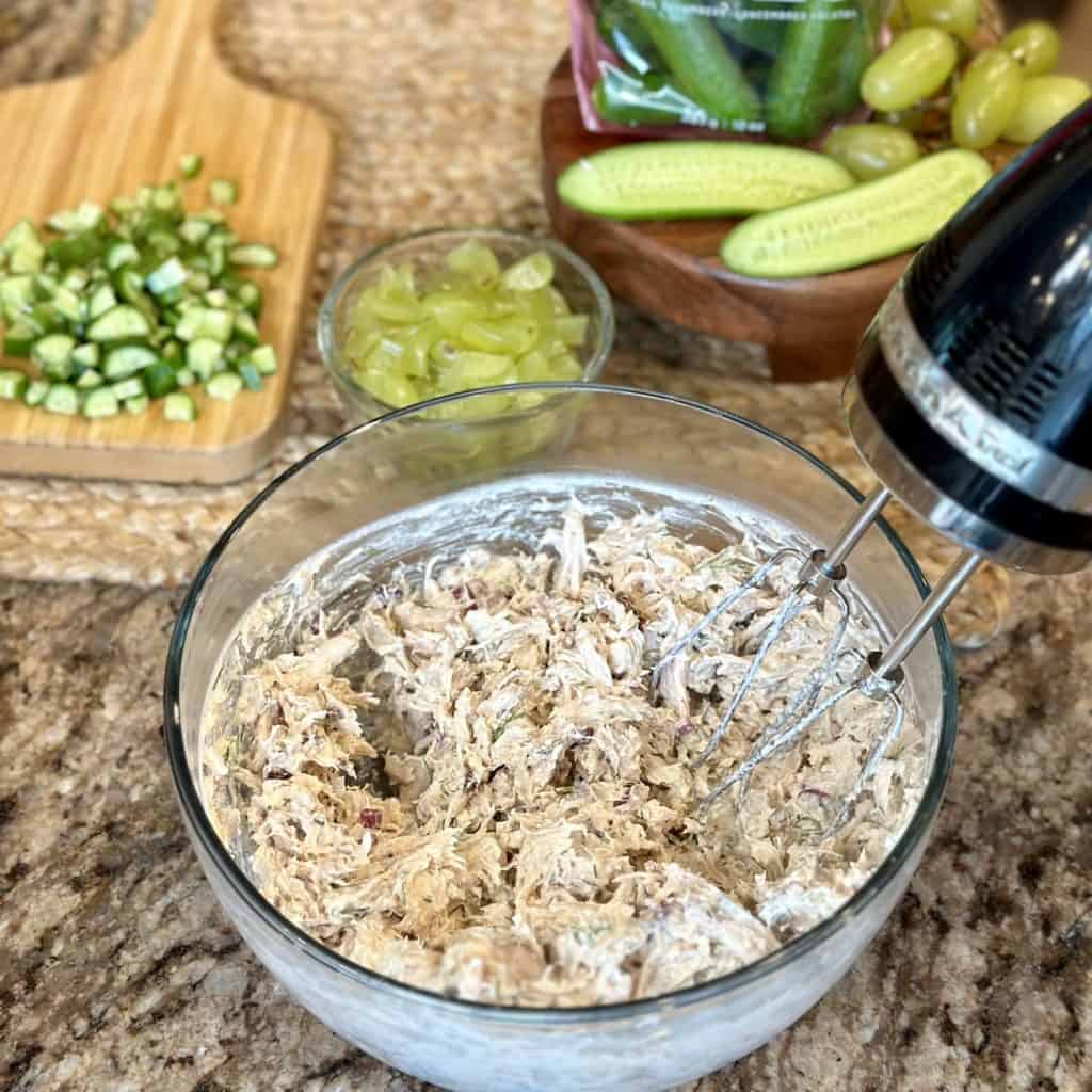 A bowl of blended chicken salad ingredients.