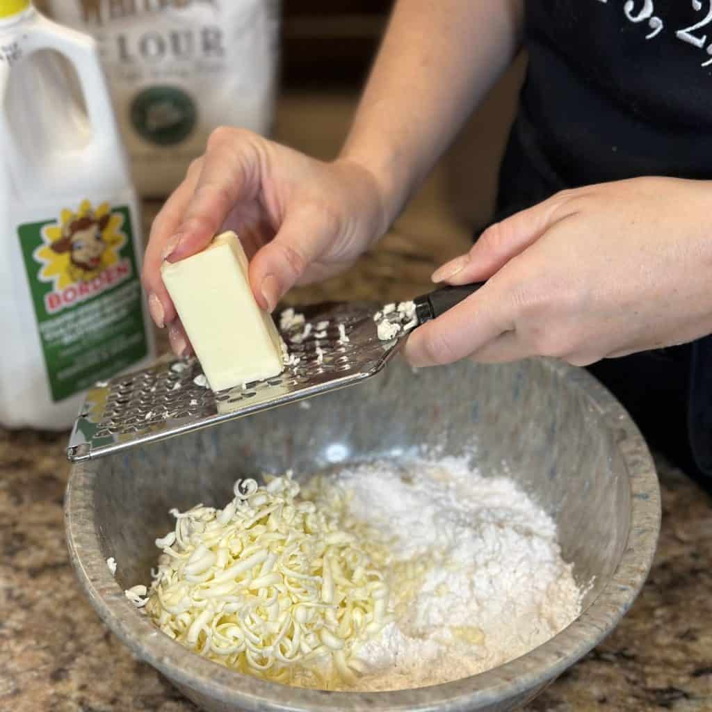 Grating butter into flour.