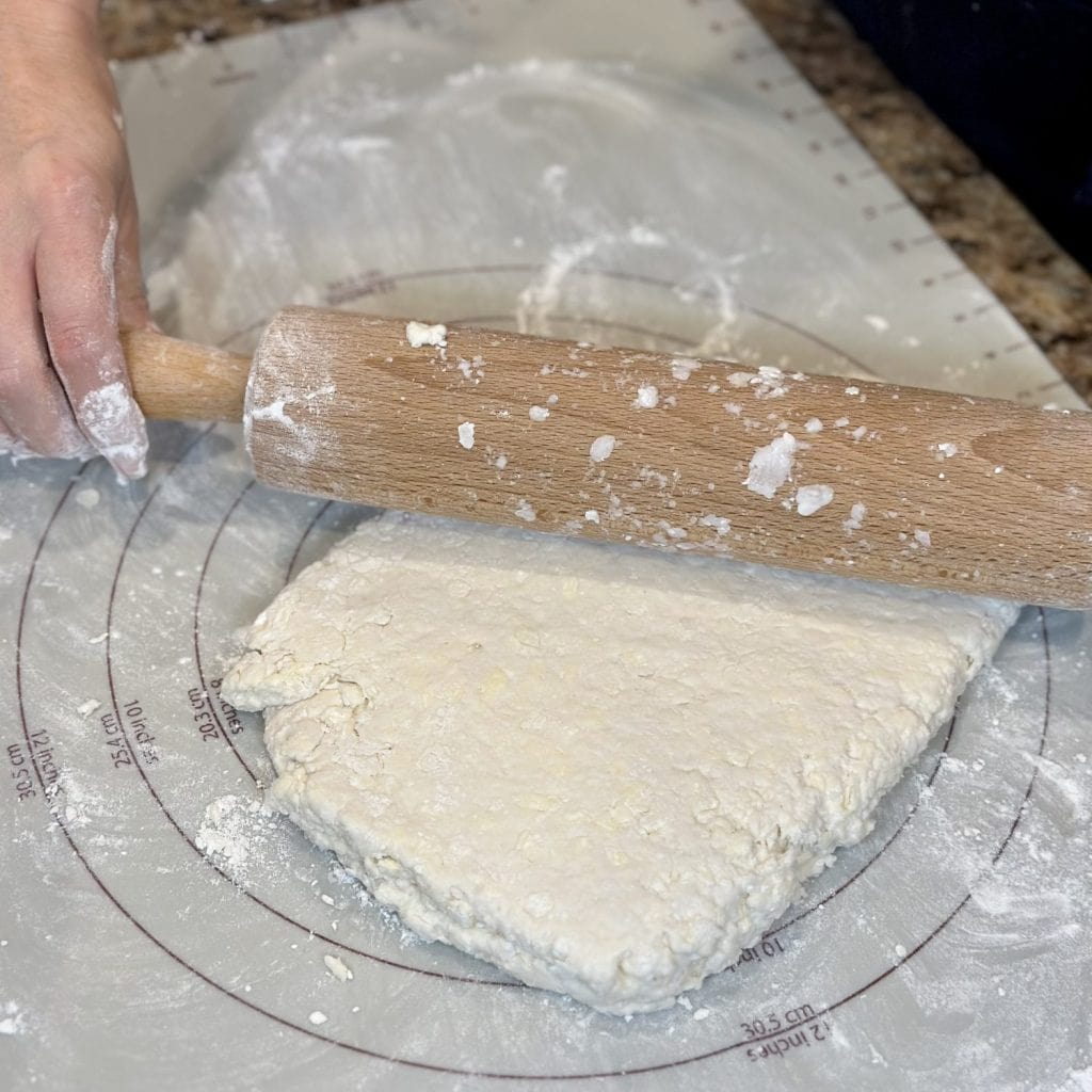 Rolling out biscuit dough.