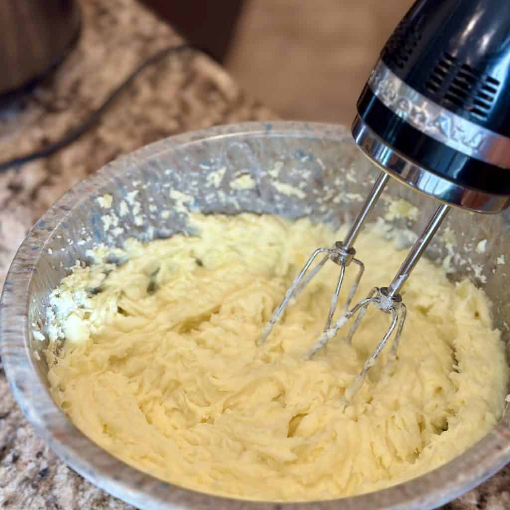A hand mixer whipping mashed potatoes.