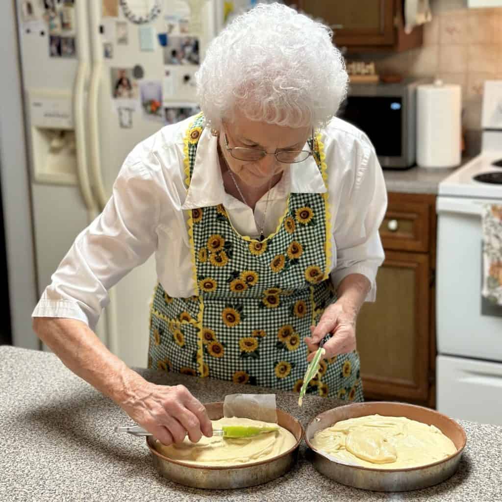 Spreading batter in 2 round pans.