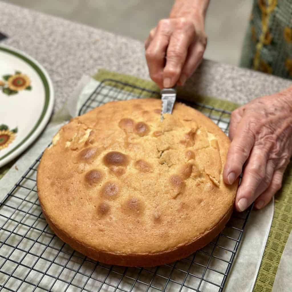 Shaving cake off the top for an even layer.