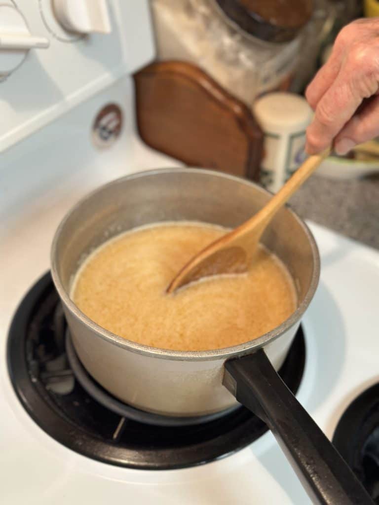 Boiling icing on the stovetop.