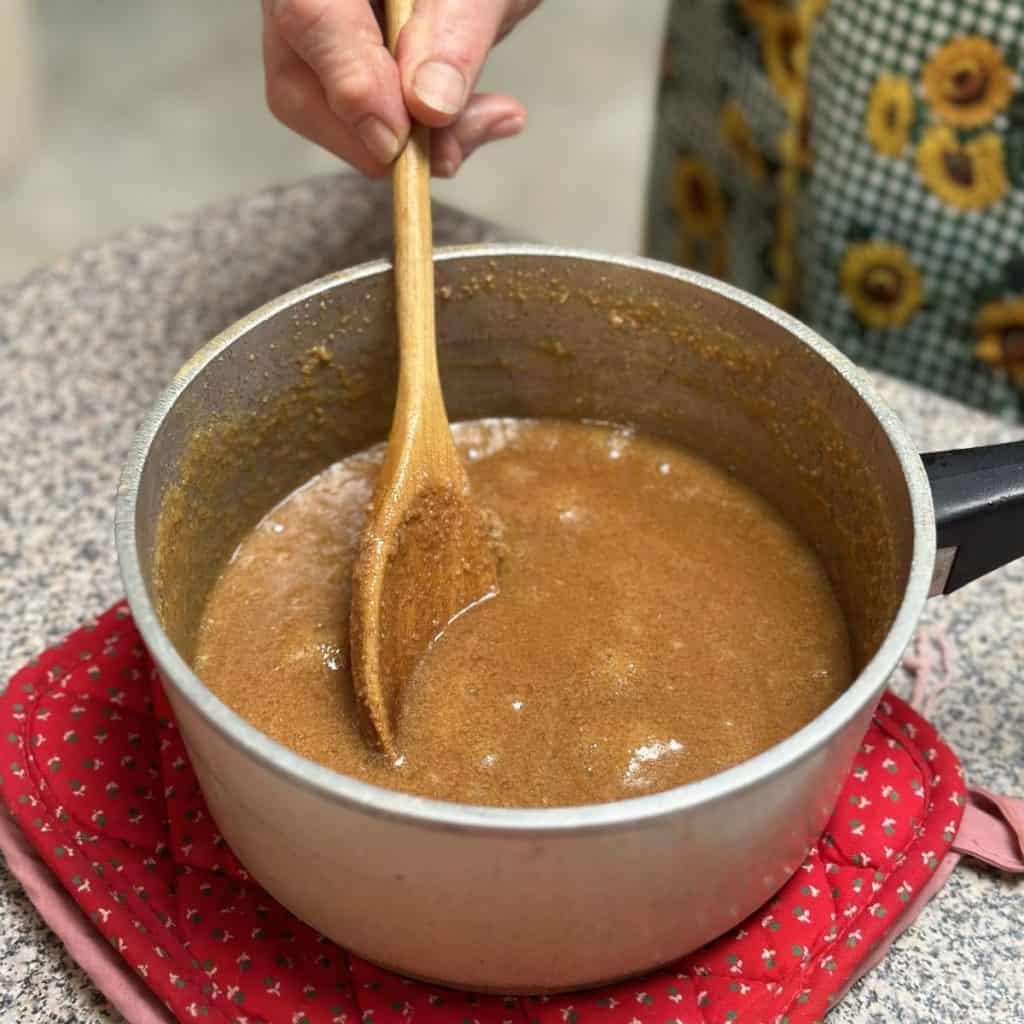 Whipping together icing ingredients in a pan.