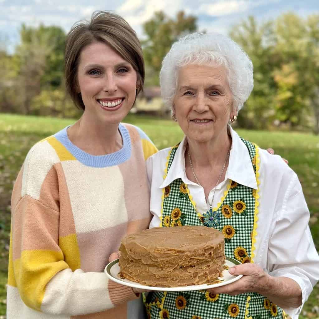 A picture of granny and Laura Ashley holding a 1234 cake.
