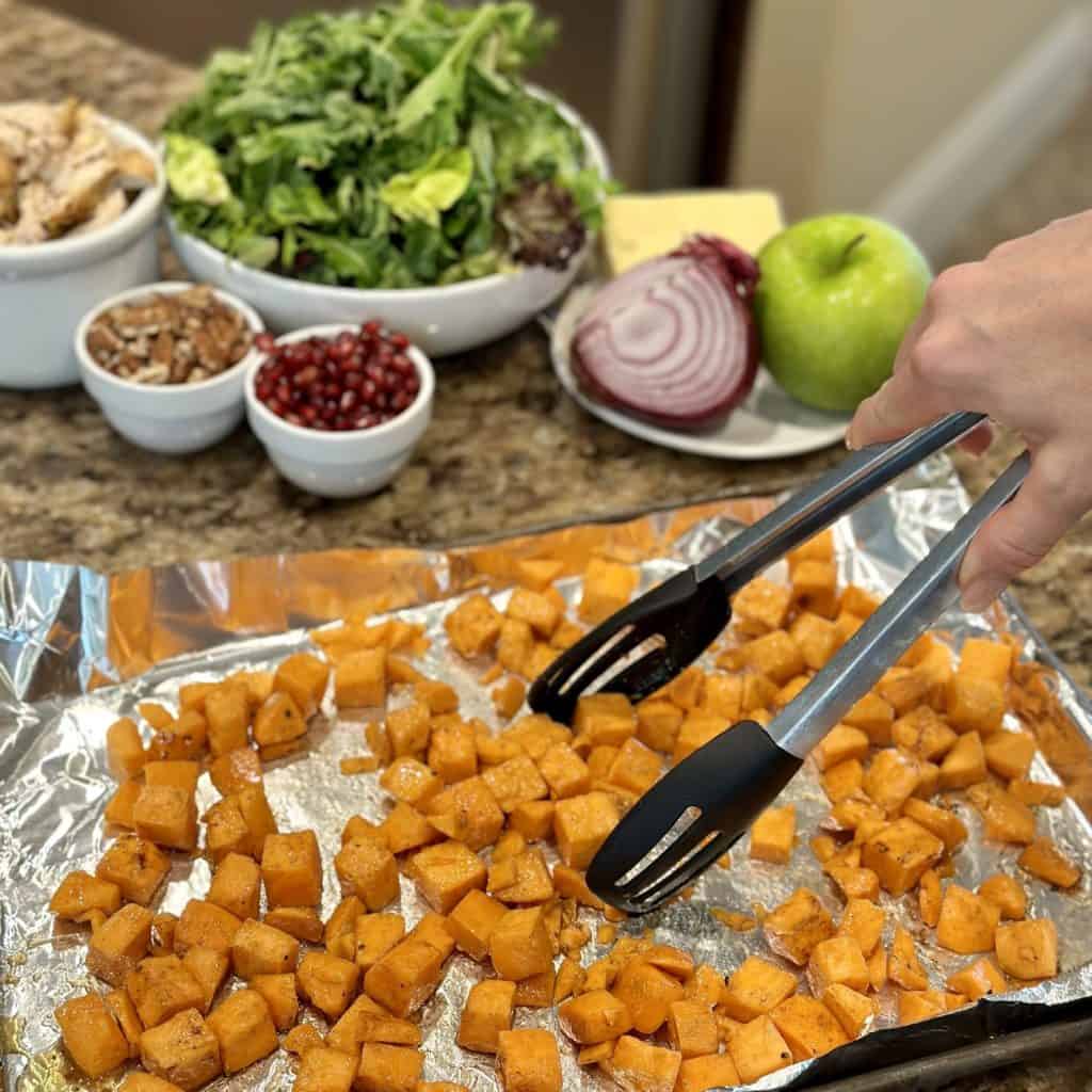 Making the roasted sweet potato salad component.