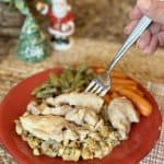 A fork going in for a bite of chicken and stuffing.