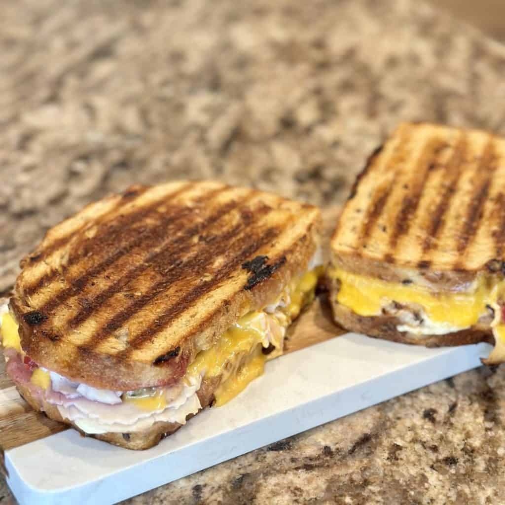 The gobbler sandwich sitting on a cutting board.