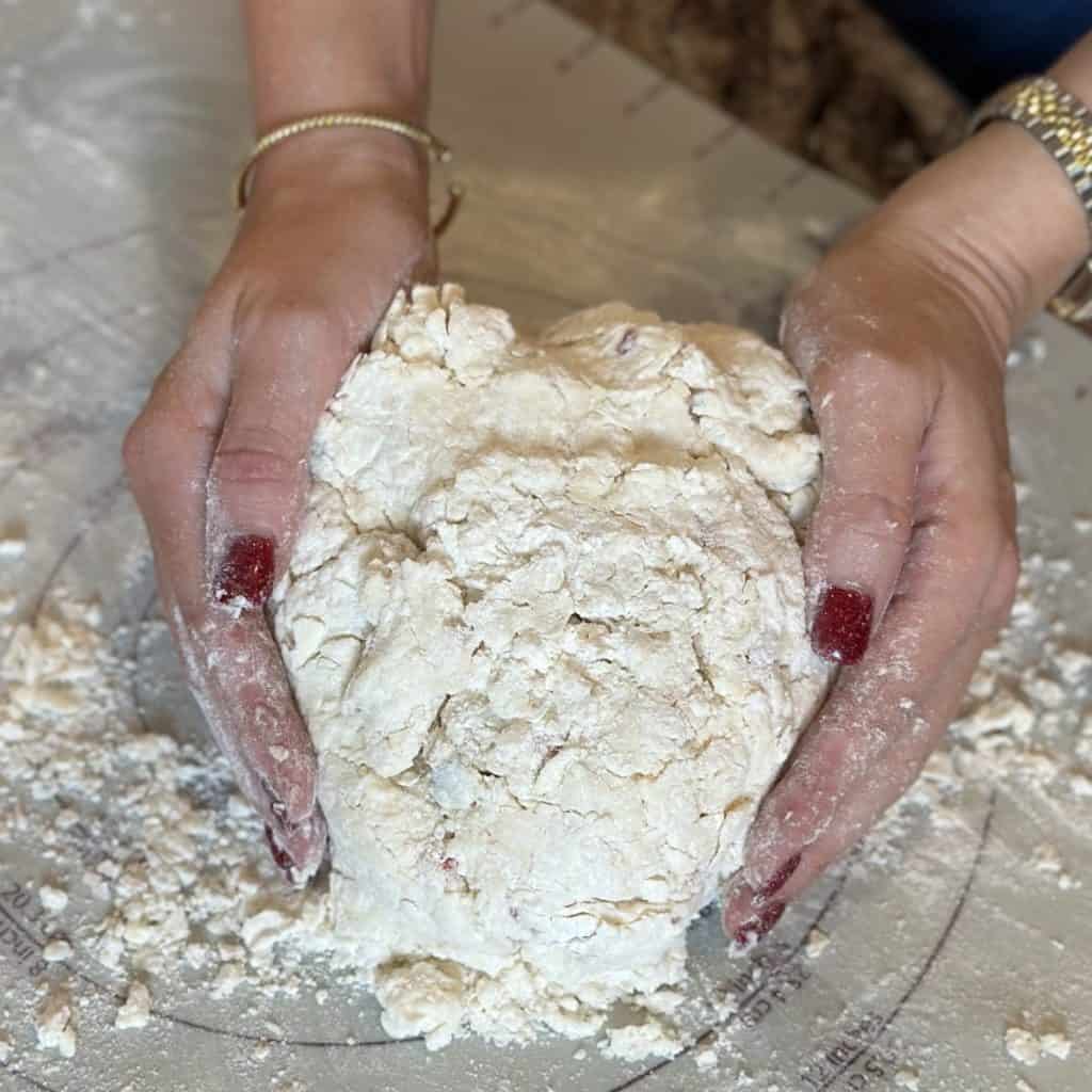 Forming biscuit dough on a mat.