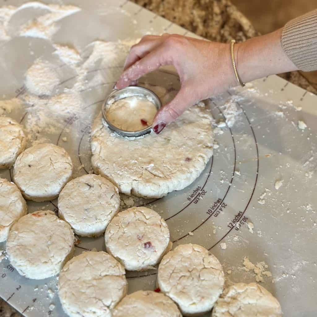 Cutting out biscuits on a baking mat.