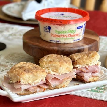 Ham, pimento cheese, biscuit sandwiches on a plate.