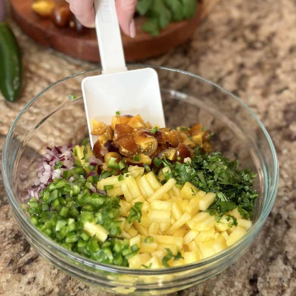 The ingredients in a bowl to make tropical pico de gallo.