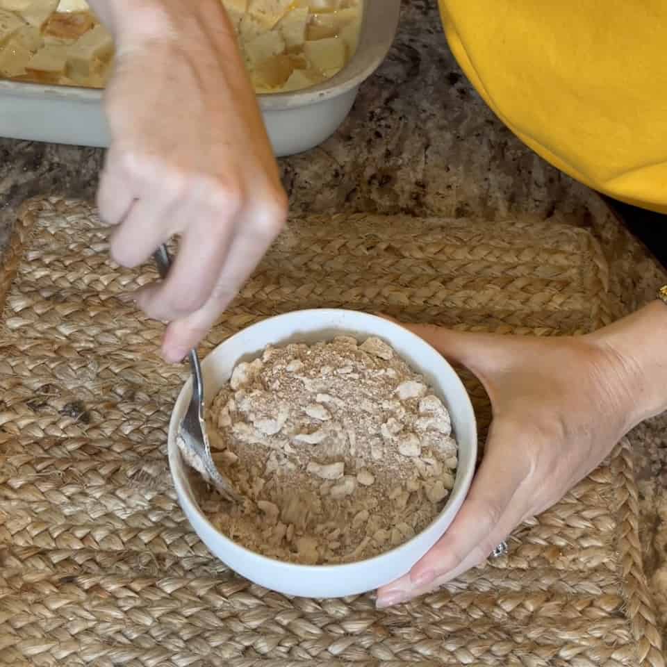 Mixing together streusel in a bowl.
