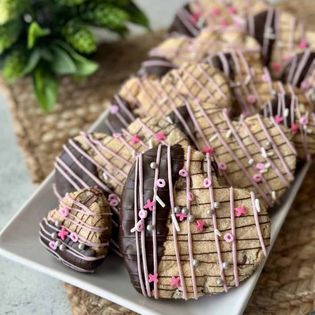 A plate of chocolate chip valentine heart shaped cookies.