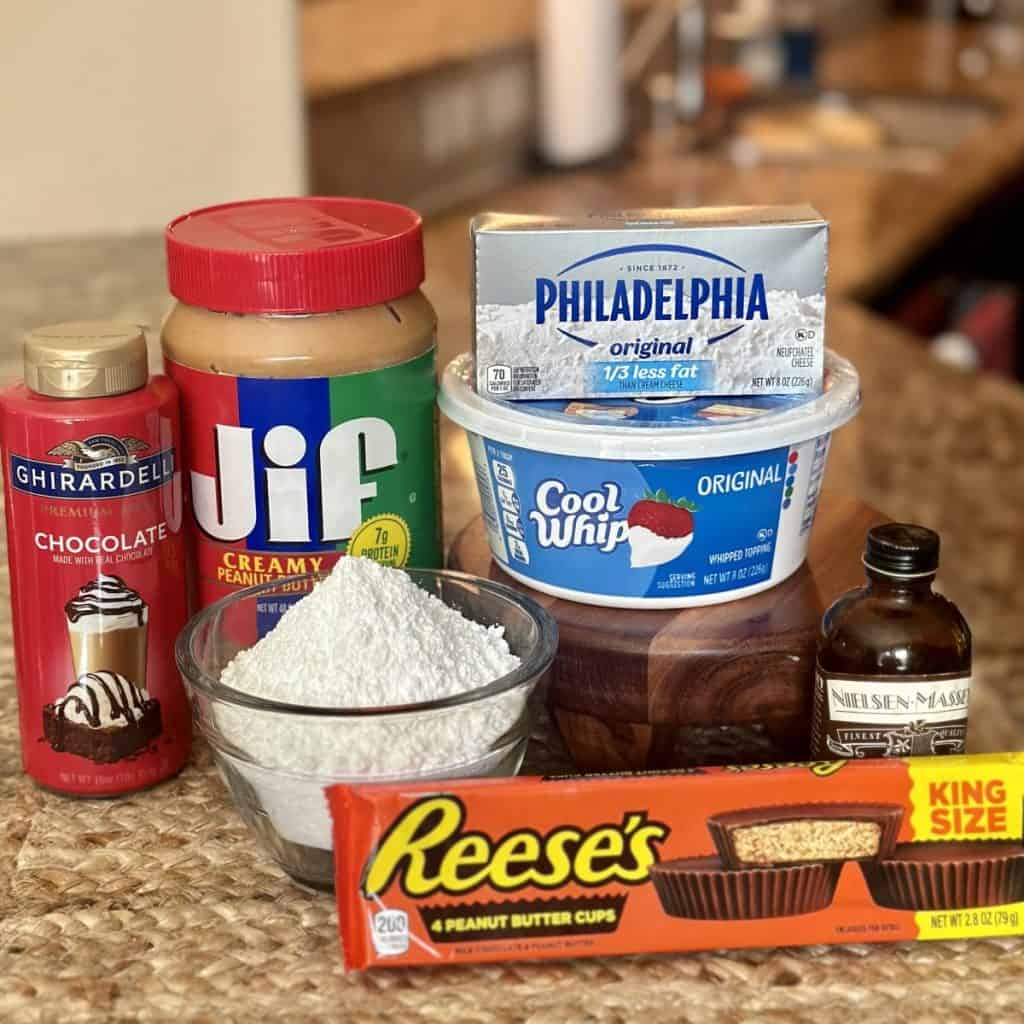 The ingredients to make a peanut butter frosting and garnishes for the cake.