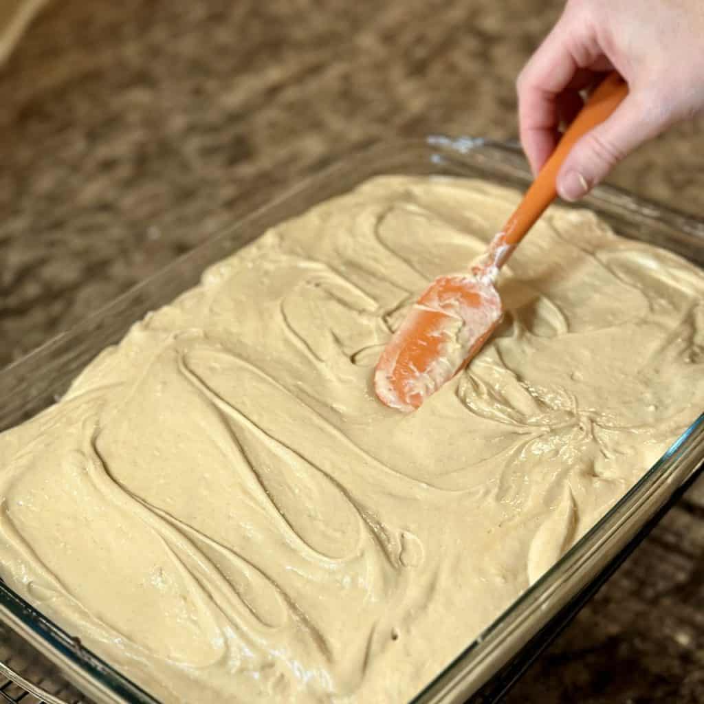 Spreading icing on a cake.