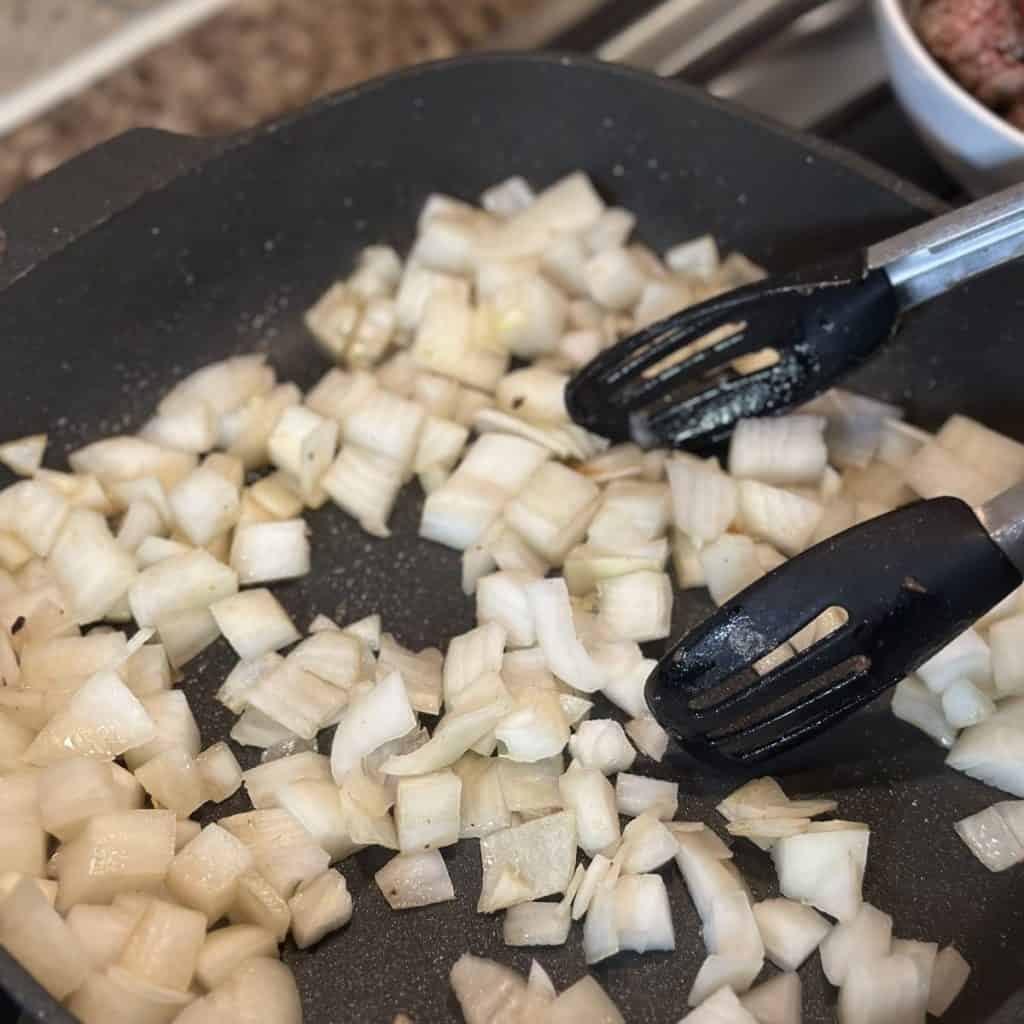 Sautéing onions in a skillet.