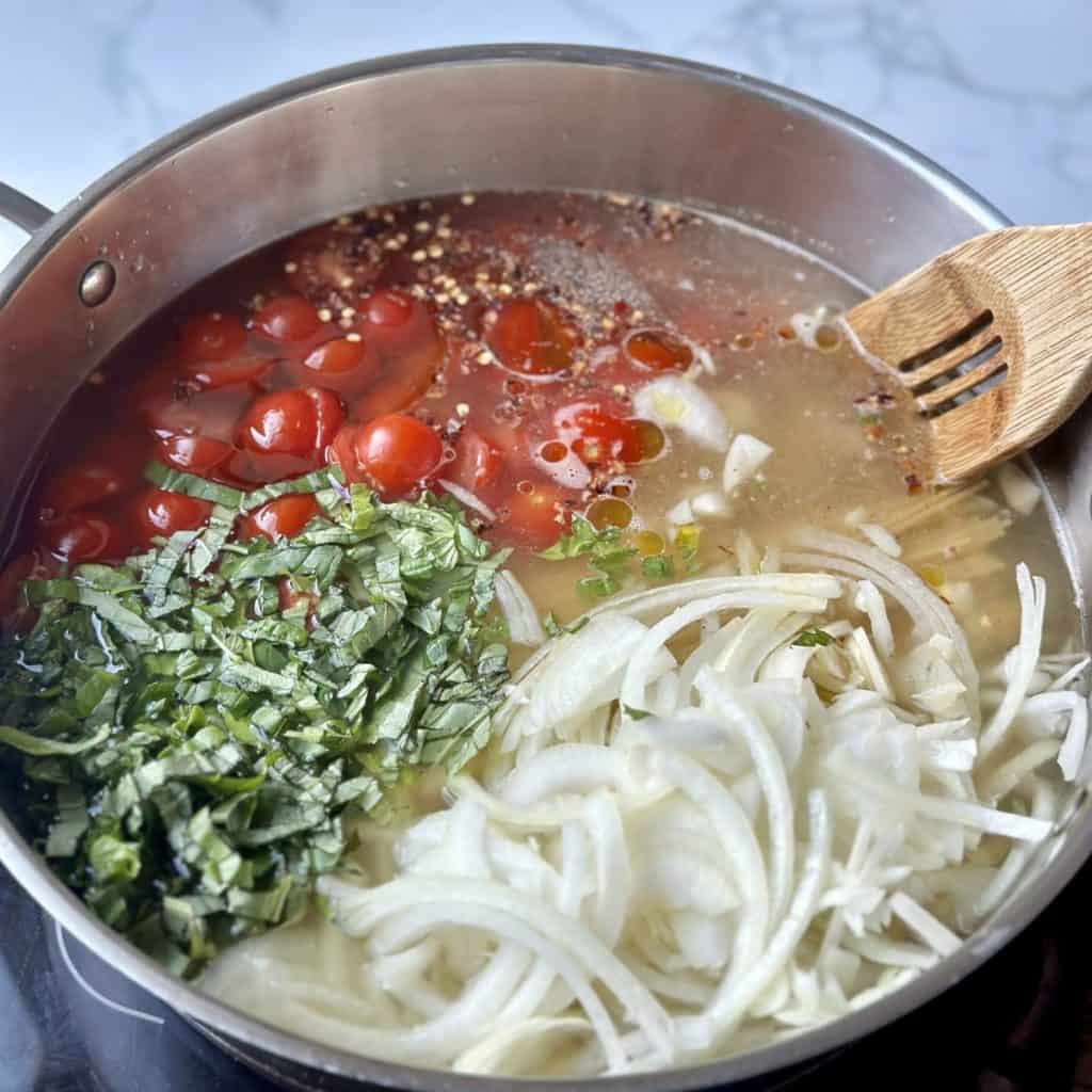 The ingredients in a pan for one pan pasta.