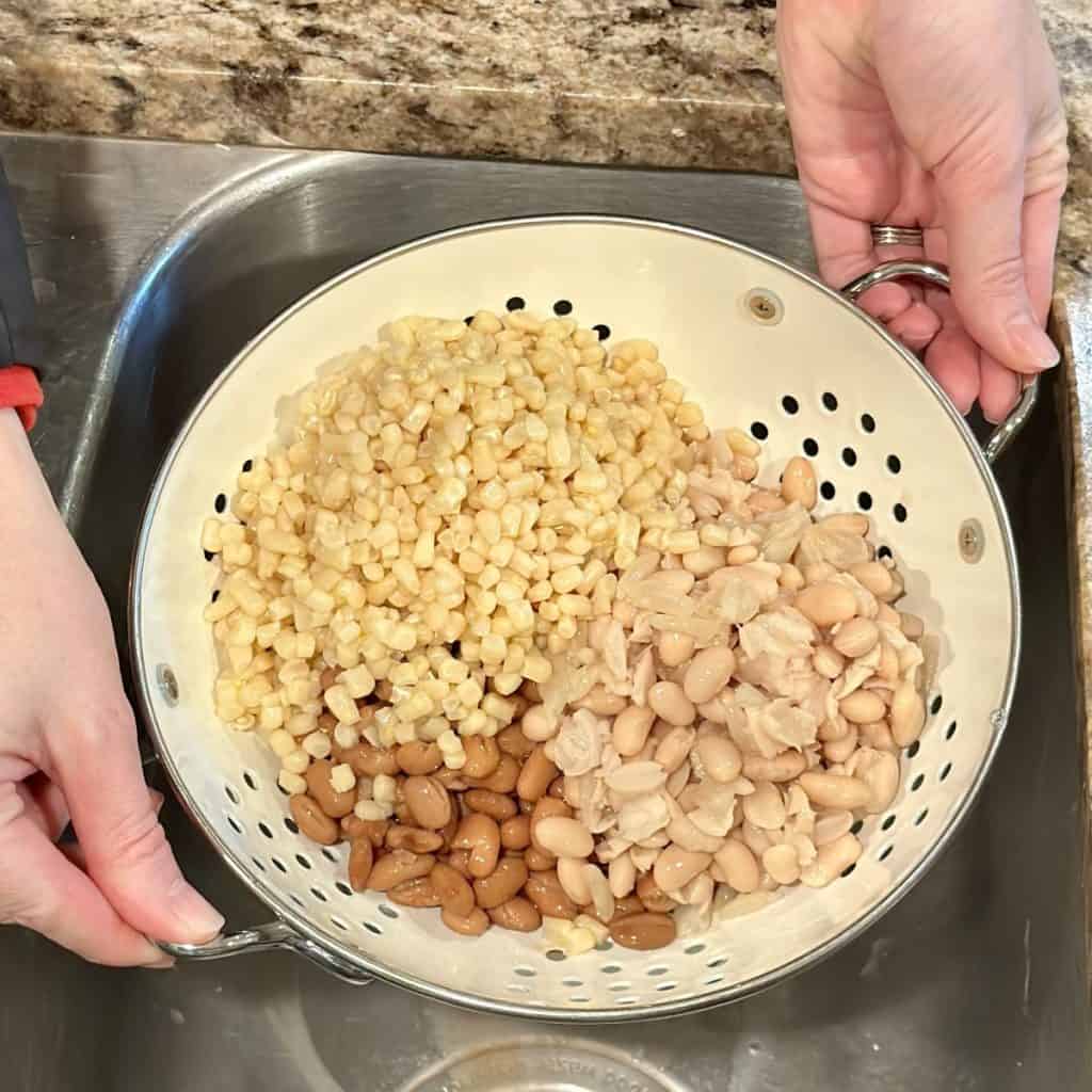 Draining beans and corn in a colander.