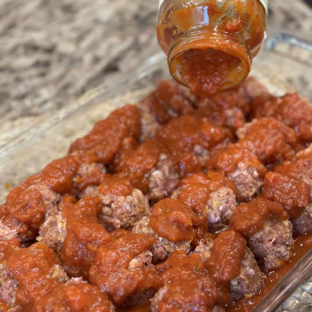 Pouring sauce on meatballs