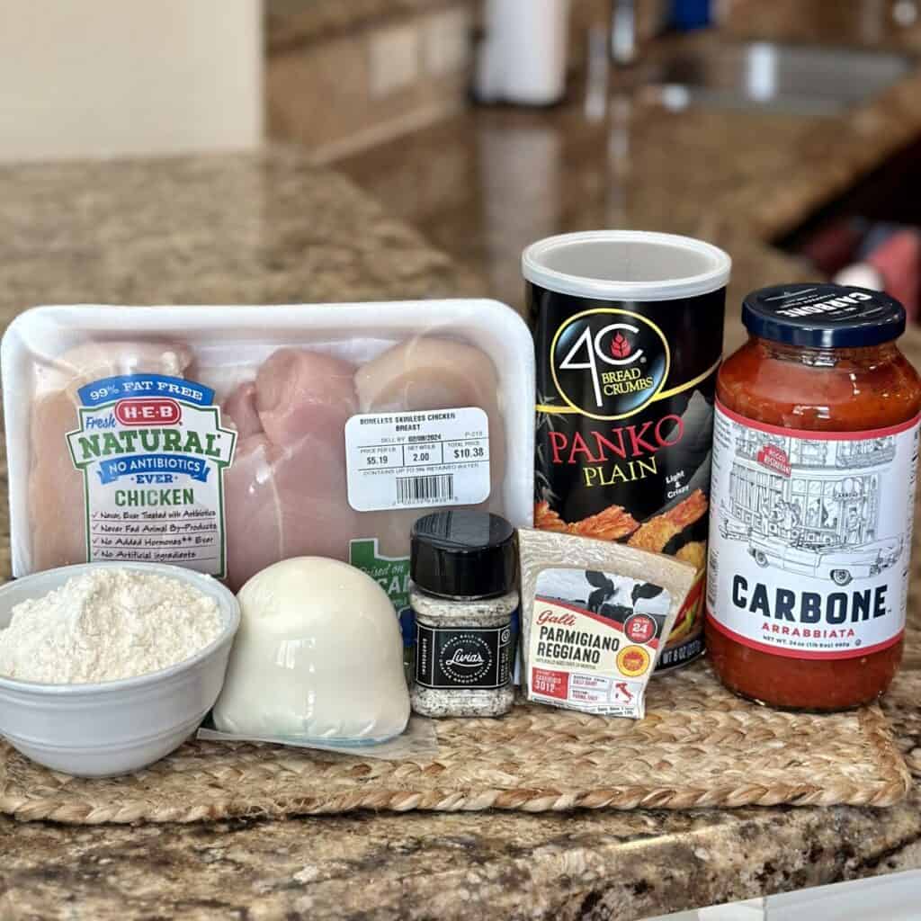 Ingredients to make chicken parmesan.