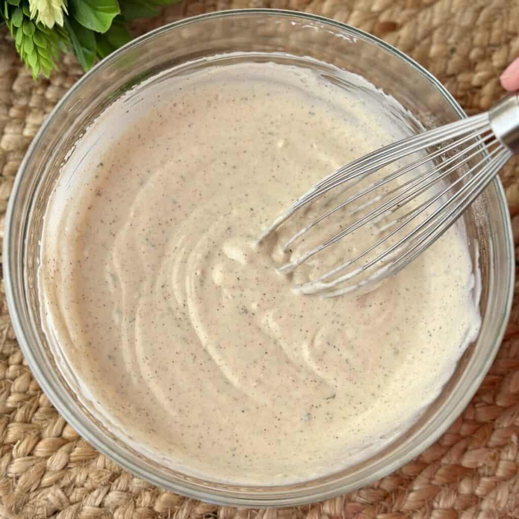 Mixing ranch dressing in a bowl.