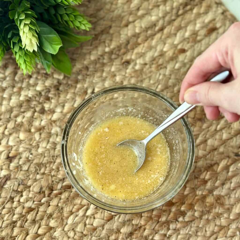 Mixing garlic butter in a bowl.