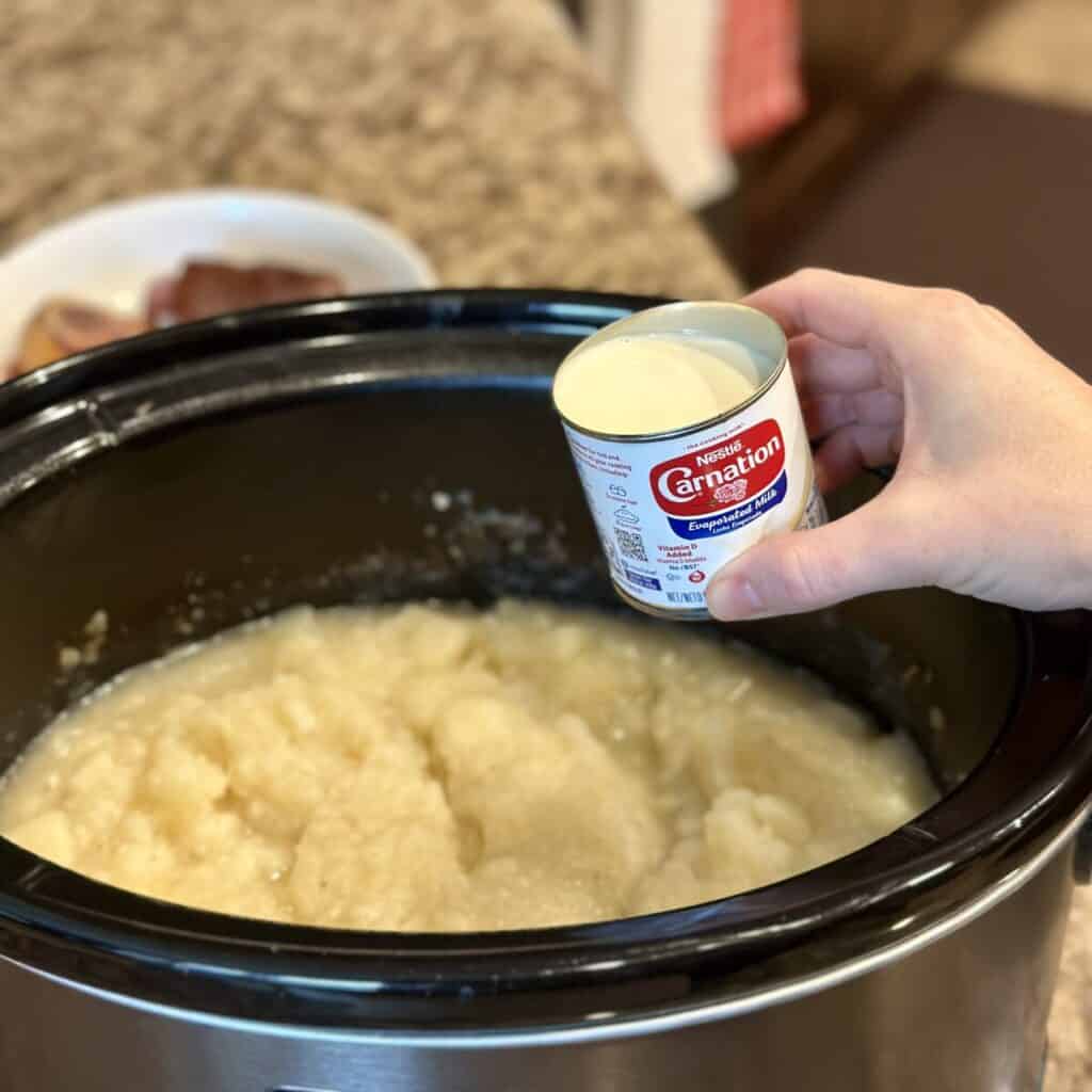 Adding cream to a crockpot soup.